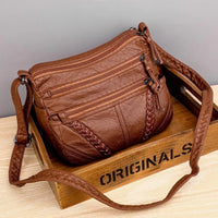 Relaxed Leather Crossbody Bag with Multi-Zip Pockets and Braid Detail